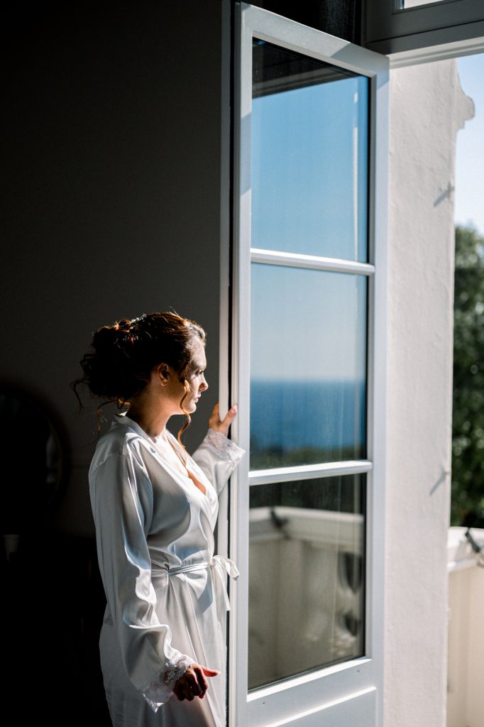 mariée qui regarde par la fenêtre de la chambre du Castel Bay